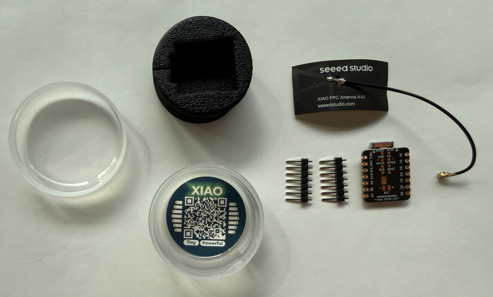 Package contents: the board, the A-01 FPC antenna, two pin headers and the XIAO storage jar